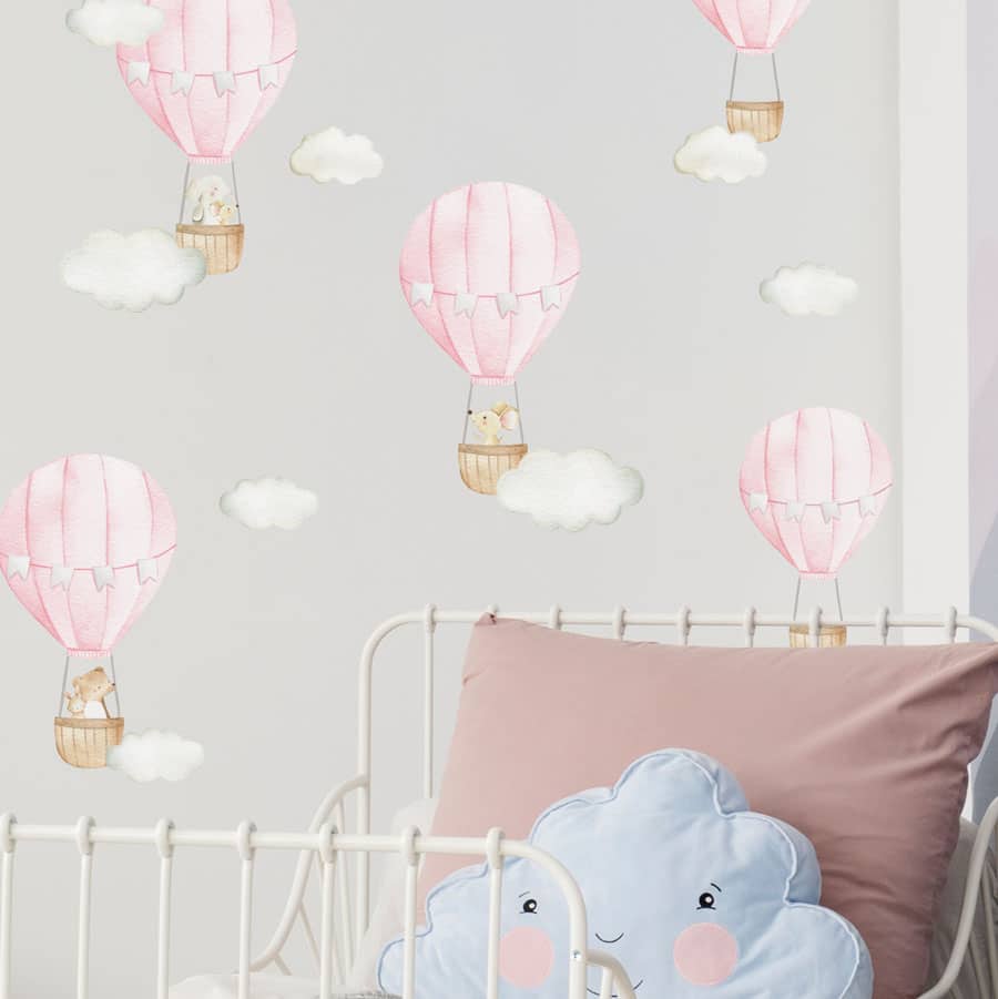 pink hot air balloon wall stickers on a child's bedroom wall above a bed