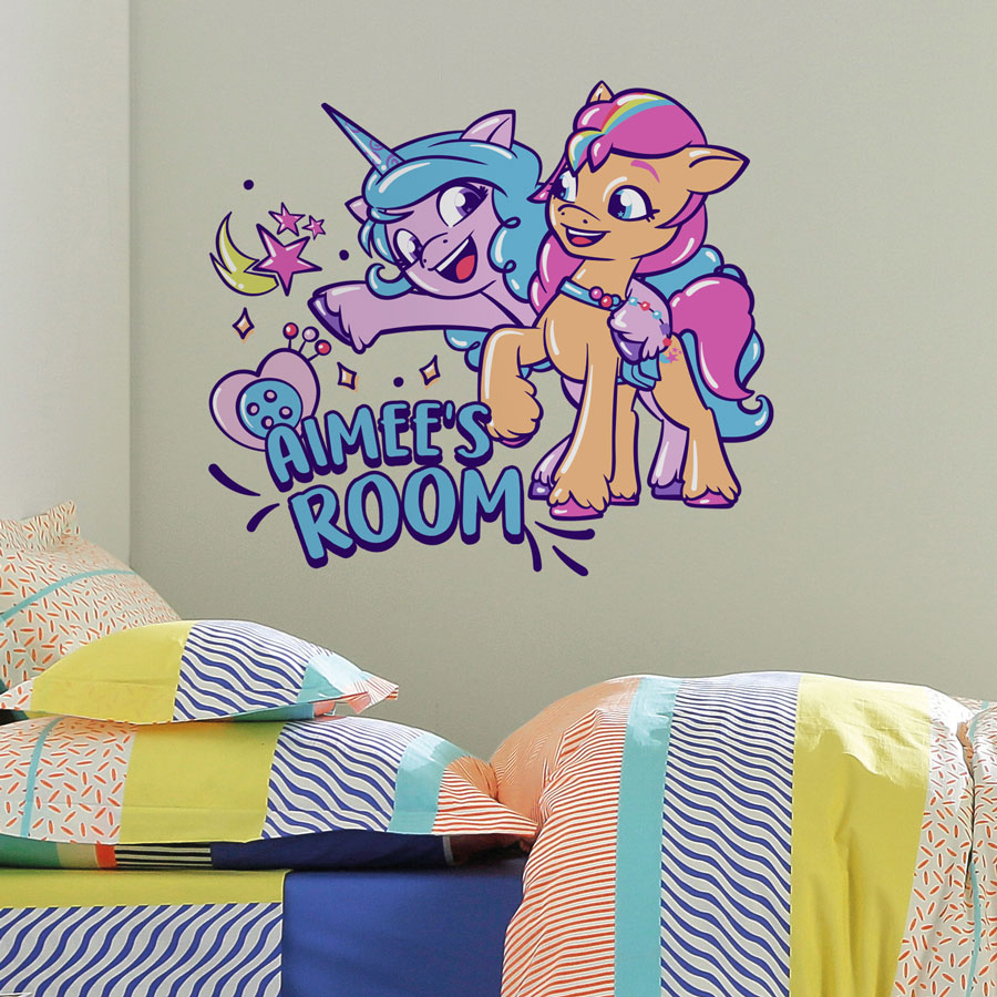 Personalised Sunny & Izzy wall sticker shown on a light green/ grey wall above a colourful bed set