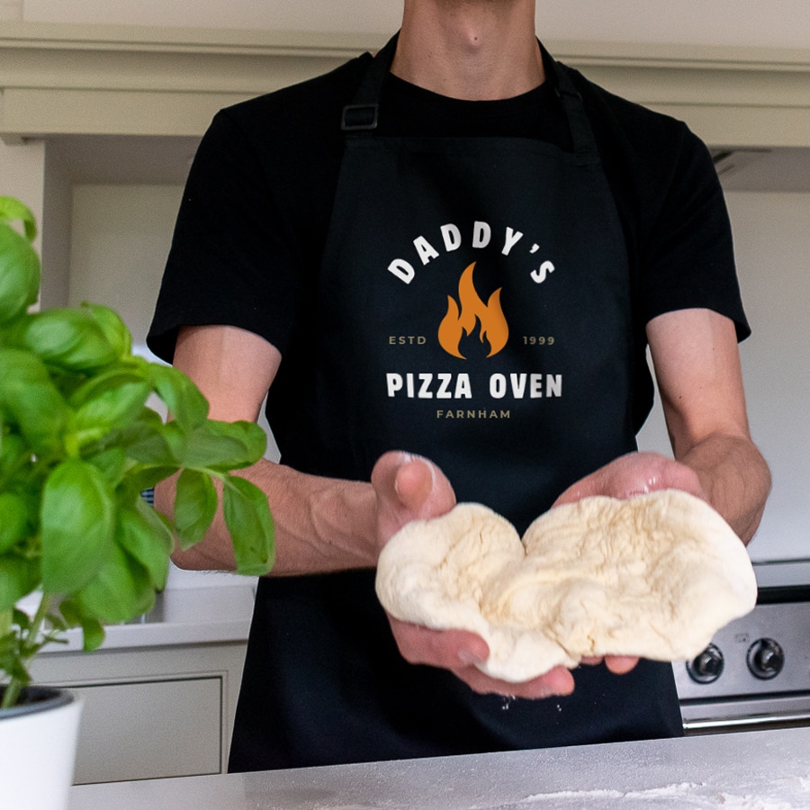 Personalised Pizza Flame Apron in black making a pizza