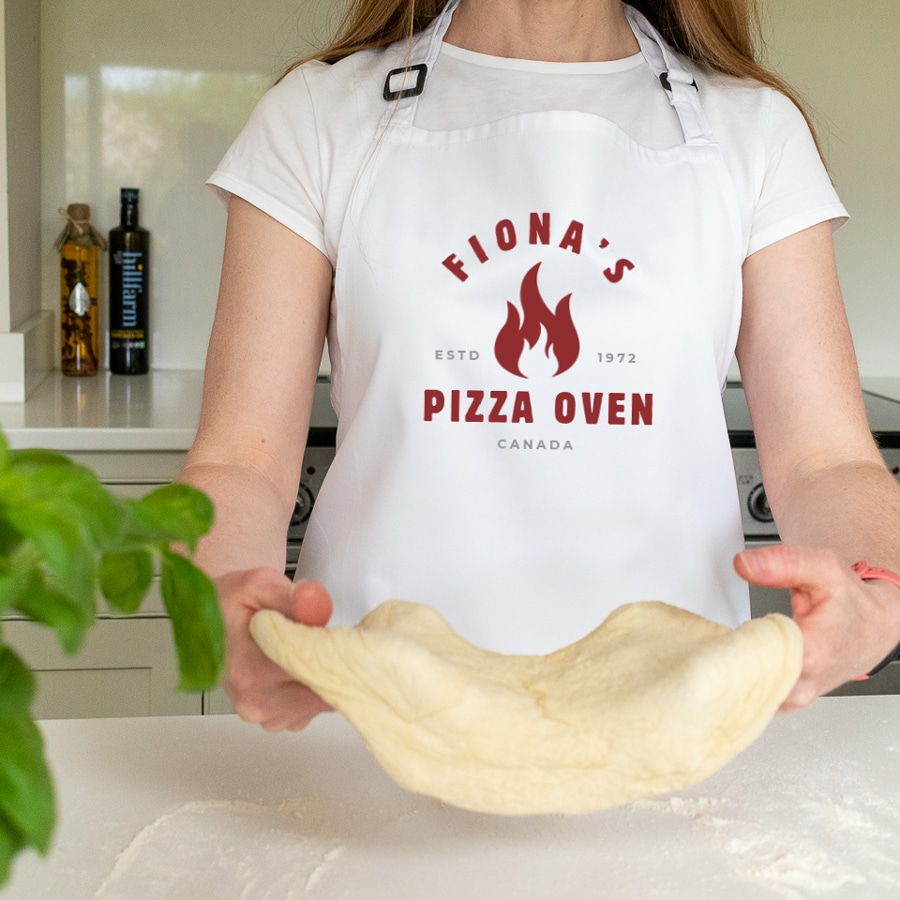 Personalised Pizza Flame Apron in white making a pizza